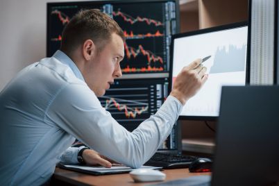 man-working-online-in-the-office-with-multiple-com-X4PABQM-scaled.jpg